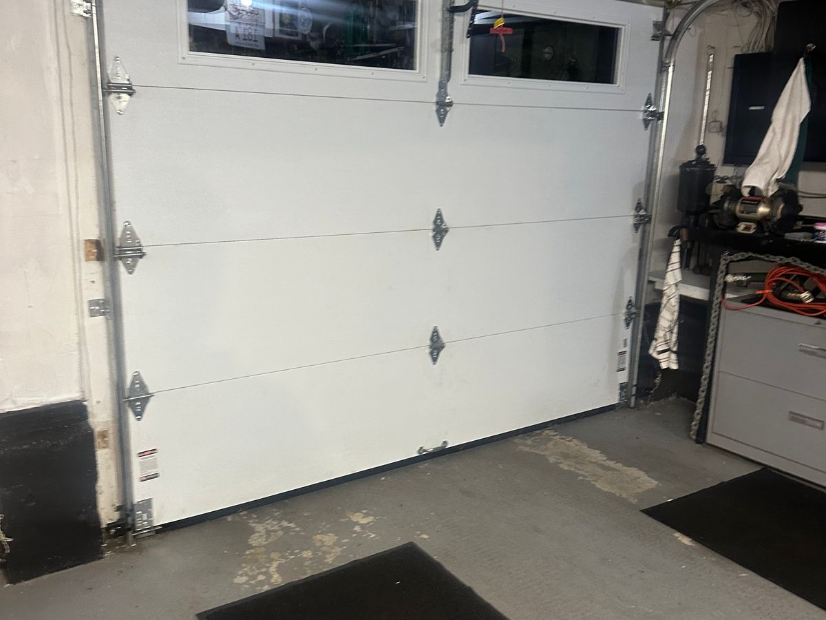 Commercial garage door interior view with window and hardware